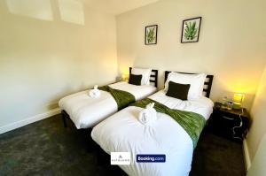 two twin beds in a room with a sign that says edinburgh at The Jungle Comfy & Spacious 3BR by AltoLuxo Short Lets & Serviced Accommodation With Free WiFi & Parking in Bristol