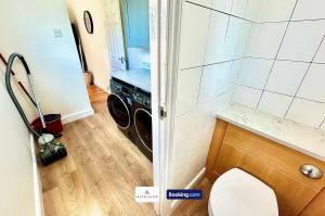 a bathroom with a washer and dryer in a room at The Jungle Comfy & Spacious 3BR by AltoLuxo Short Lets & Serviced Accommodation With Free WiFi & Parking in Bristol +18 photos