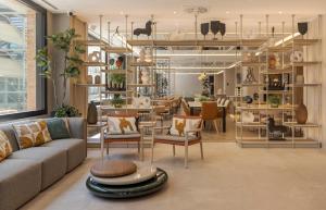 a living room with a couch and chairs and a table at Ilunion Romareda in Zaragoza