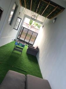 a living room with a couch and a window at EmeraldSuites Blossom Court Alalubosa GRA in Ibadan