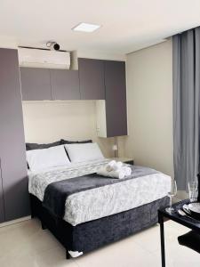a bedroom with a bed with two towels on it at Studio Home 64 Luxo in Mogi das Cruzes +60 photos