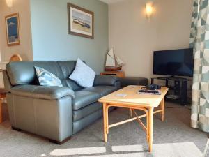 a living room with a couch and a coffee table at Sunrise Bay - Mount Brioni in Downderry