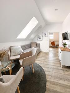 a white living room with a couch and chairs at Na Kmíně in Obříství