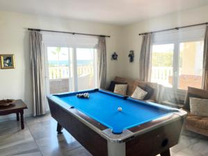 a living room with a pool table at Villa Aurelia Sea views Heatable Pool - Billiard Ping-pong Fooball table - Beach & All at 500 m in La Cala de Mijas