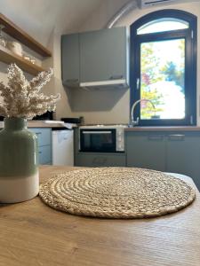 a kitchen with a table with a vase with a plant at Arch Residence, studio 3, Vroulidia in Katarráktis +5 photos