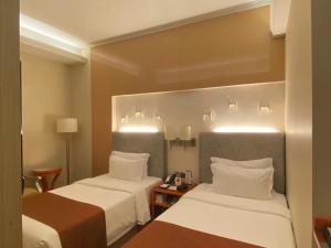 Postel nebo postele na pokoji v ubytování Hotel Metropole