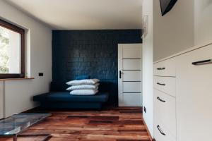 a living room with a blue couch and a window at Komfortowy apartament w spokojnej dzielnicy in Wrocław +38 photos