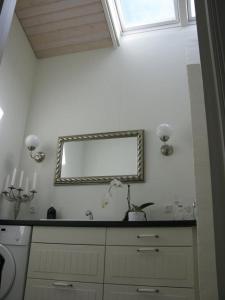 a bathroom with a mirror and a sink at Nice Home In Nykøbing Sjælland W in Nykøbing Sjælland