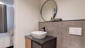 a bathroom with a sink and a mirror on a counter at Table Mountain View Apartment in Cape Town +17 photos
