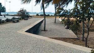 a park with a bench and trees on a beach at Aeroporto e praia loft casal in Vitória