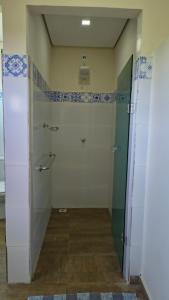 a bathroom with a shower and a glass door at Selah Estação Ecológica in Cocalzinho de Goias