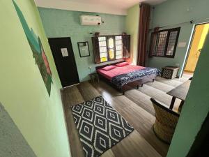 a bedroom with a bed in a room with green walls at Utsav riverbank homestay in Haldwāni +17 photos
