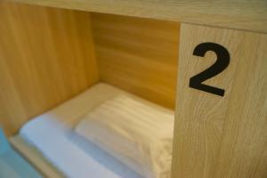 a wooden block with a small bed in a room at Waveflo Hostel 浪花青旅 in Hong Kong