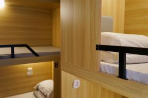 a small room with two bunk beds in it at Waveflo Hostel 浪花青旅 in Hong Kong