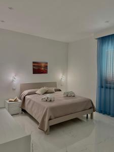 a bedroom with a bed with two towels on it at Luxury Magre in Ischia Town