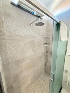 a shower with a glass door in a bathroom at Luxury Magre in Ischia Town