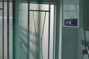 a window with a curtain and a camera on it at Waveflo Hostel 浪花青旅 in Hong Kong