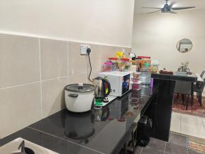 a kitchen with a counter with a coffee maker on it at Alangstay in Kampong Jelatang +1 photo