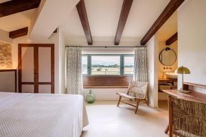 a bedroom with a bed and a window and a chair at Son Seriol in Inca +59 photos