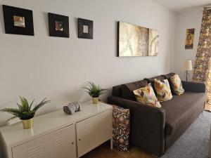 a living room with a couch and a table at The Colors House, 646 y 524 - Private Apartments in Costa Teguise