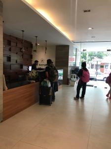 a group of people standing at a counter in a store at Cityscape Grand Tower Condo, studio unit in Cebu City