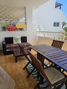 a dining room with a table and chairs and a couch at The Colors House, 646 y 524 - Private Apartments in Costa Teguise