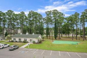 an aerial view of a house with a putting green at 2 Bedroom Golf Course Oasis At River Oaks in Myrtle Beach
