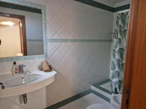 a bathroom with a sink and a mirror at Oceano Azul in Porto Santo +52 photos