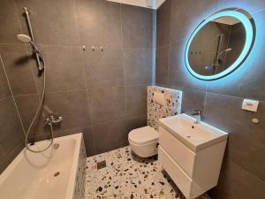 a bathroom with a sink toilet and a mirror at Apartments Novum in Novi Vinodolski +32 photos