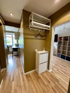 a room with green walls and a white cabinet and a desk at Liepājā 4:10 pm in Liepāja