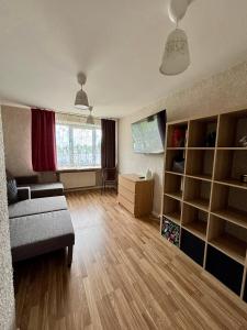 a living room with a couch and a table at Liepājā 4:10 pm in Liepāja