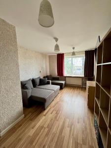 a living room with a couch and a table at Liepājā 4:10 pm in Liepāja +24 photos