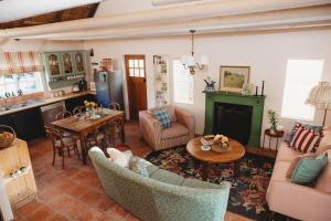 a living room filled with furniture and a table at Cardigan Cottage in McGregor
