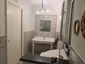 a bathroom with a sink and a mirror at Villa Claudia in Quiliano +44 photos