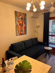a living room with a couch and a painting of a woman at Apartamento Luna Blanca, La Mata, 300 m from the sea and sandy beach plus swimming pool in La Mata +29 photos