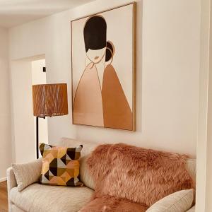 a living room with a couch and a painting on the wall at Pures Glück Seligenstadt in Seligenstadt