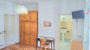 a kitchen with a table and a sink in a room at Casa Lucia in Casamicciola Terme