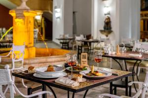 a table with plates of food and glasses of wine at Royal Savoy Sharm El Sheikh in Sharm El Sheikh