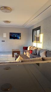 a living room with a couch and a table at Villa Kazim in Berkane