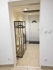 a hallway with a white door and a ladder at Appartement proche du port in Mèze