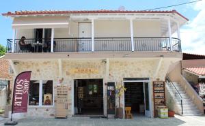 a building with a balcony on top of it at Comfy Apartments Center in Nikiti