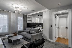 a living room with a couch and a table at Ena Boutique Hotel & Residences in Bodrum City