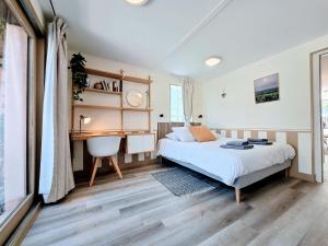 a bedroom with a bed and a desk at Appartement 2 chambres, Terrasses, Rez-de-Chaussée in Chablis