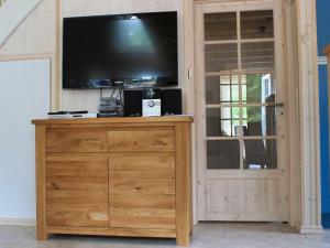 a entertainment center with a flat screen tv on top at Feenwald - Baabe in Baabe