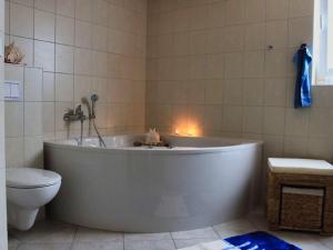 a bath tub in a bathroom with a toilet at Feenwald - Baabe in Baabe +13 photos