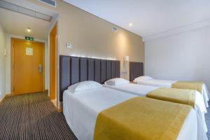 Cama o camas de una habitación en Hotel Azinheira by RIDAN Hotels