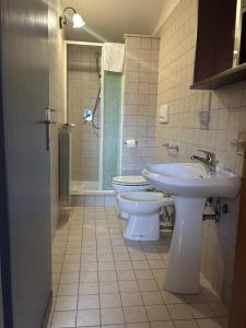 a bathroom with two toilets and a sink and a shower at Agriturismo Colle Sant Angelo in Serrone +10 photos