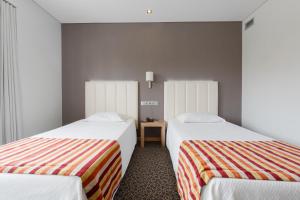 Cama o camas de una habitación en Hotel Azinheira by RIDAN Hotels