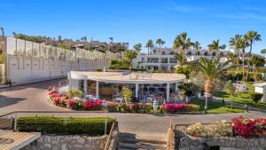 a view of a building with flowers and palm trees at Royal Savoy Sharm El Sheikh in Sharm El Sheikh
