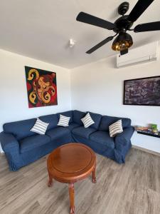 a living room with a blue couch and a table at Čiovo Bay Apartment in Slatine